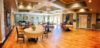 Interior view of a bright common area with tables and chairs