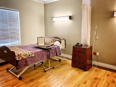 Private resident room with a hospital bed and furniture