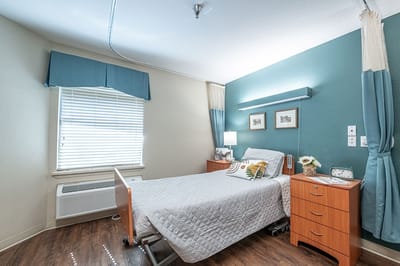 A cozy resident room with a bed and window