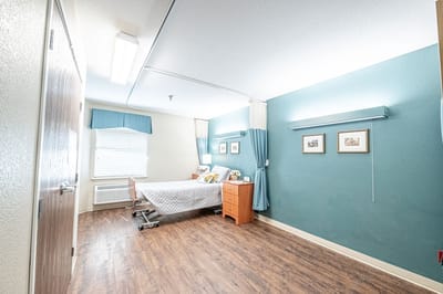 A cozy private resident room with bed and furnishings