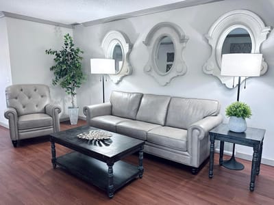 A cozy sitting area with a couch and decorative mirrors