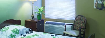 Cozy resident room with a bed and chair