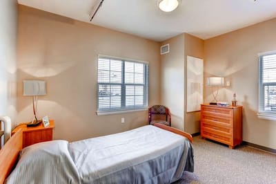 Private resident room with a bed and dresser