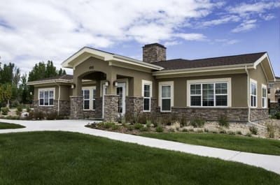 Exterior view of a senior living facility with landscaped grounds