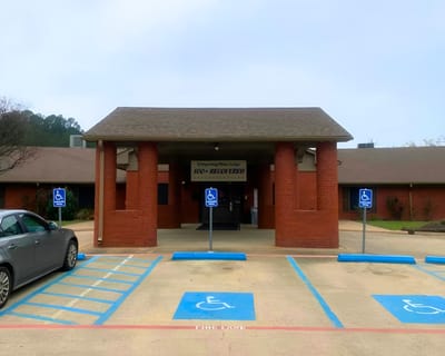 Entrance of Whispering Pines Lodge with accessible parking