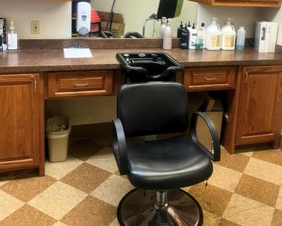 Empty hair salon chair in a facility interior