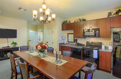 Well-furnished dining room with a large table and chandelier