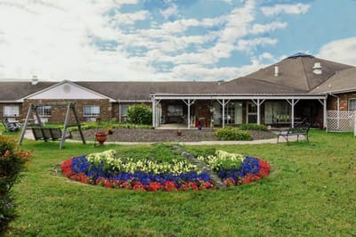 Exterior view of the facility with landscaped gardens