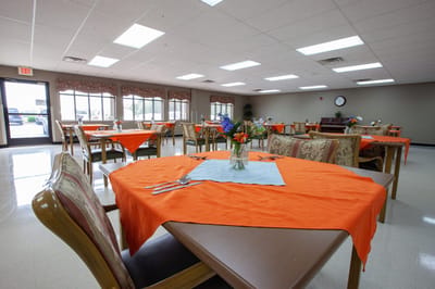 Bright dining room with orange table settings