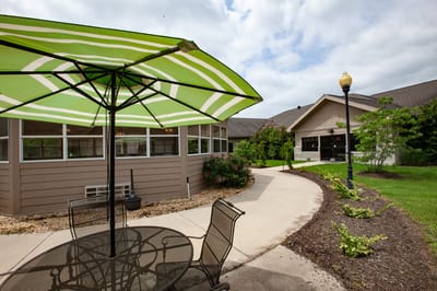 Outdoor seating area with a patio umbrella and building view