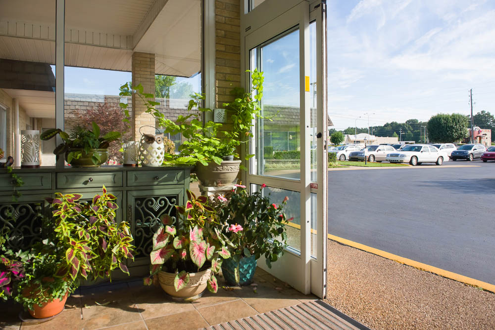 Bright entryway with plants and seating area