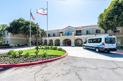 Exterior view of San Juan Hills Healthcare Center with transport vehicle
