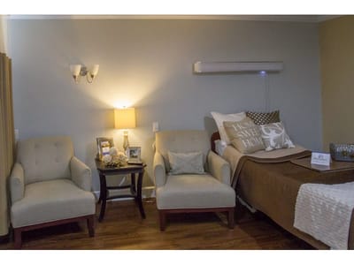 Cozy resident room with two chairs and bedside decor