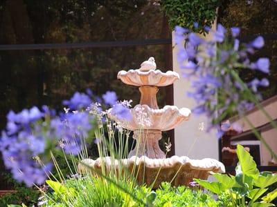 A decorative fountain surrounded by flowers