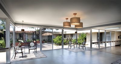 Bright common area with seating and view to garden