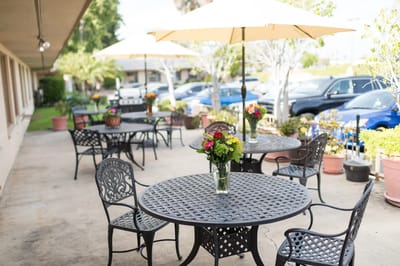 Outdoor seating area with tables and flowers