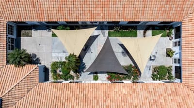Aerial view of a courtyard with shaded seating areas