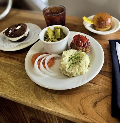 Plate of meatloaf with sides and dessert