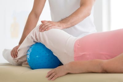 Physical therapy session with professional assistance