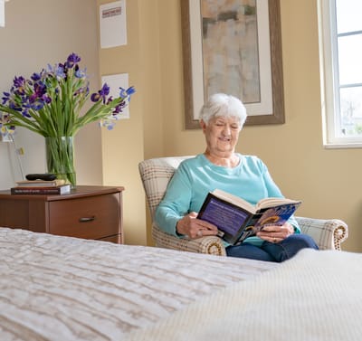 Senior woman reading in a cozy room.