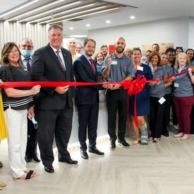 Group celebrating a ribbon-cutting ceremony