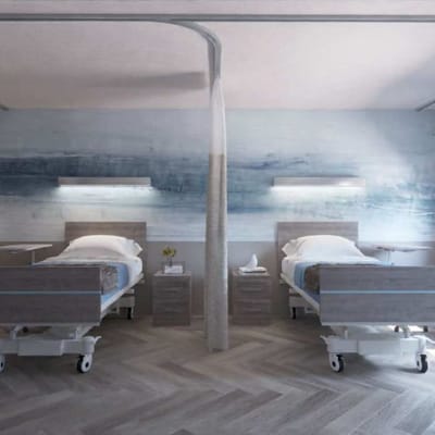 Two hospital beds in a room with calming colors.