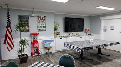 Common area with tables, decorations, and American flag
