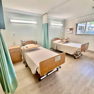 Private resident room with twin beds and natural light