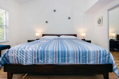 Bright, spacious bedroom with striped bedding.