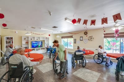 Residents socializing in a common area with decorations.