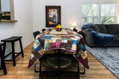 Dining table with fruit and cozy living space.