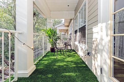 Balcony with artificial grass and seating