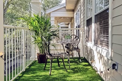 Outdoor balcony area with seating and plants