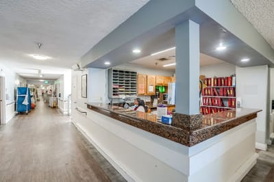 Interior view of the reception area with staff in focus.