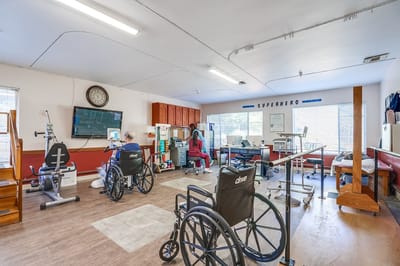 Therapy room with staff and residents interacting.