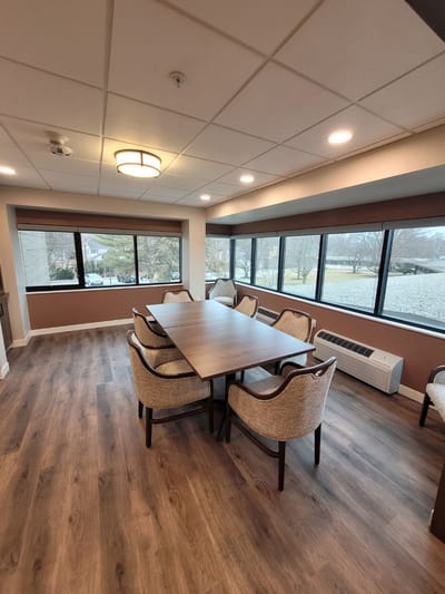 Bright common area with a large table and chairs
