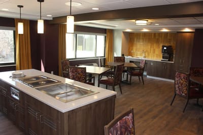 Cozy common area with dining tables and kitchen