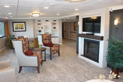 Comfortable common area with seating and a fireplace.