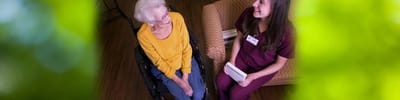 Caregiver and resident sharing a moment indoors.