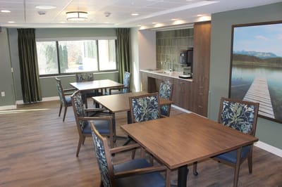 Well-lit common area with tables and chairs