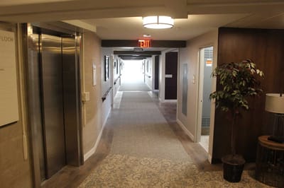 Interior hallway with elevator and light fixture