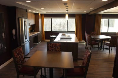 Bright and modern common area with tables and chairs.