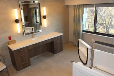 Modern bathroom interior with large mirror and tub