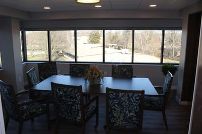 Bright common area with a large table and chairs.