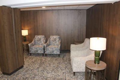 Cozy common area with seating and lamps.