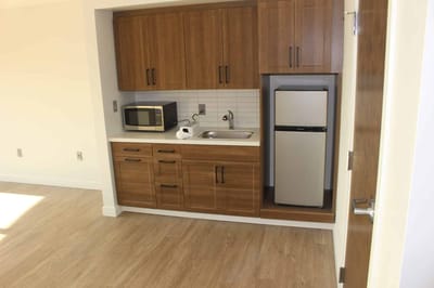 Kitchenette area with cabinets and appliances