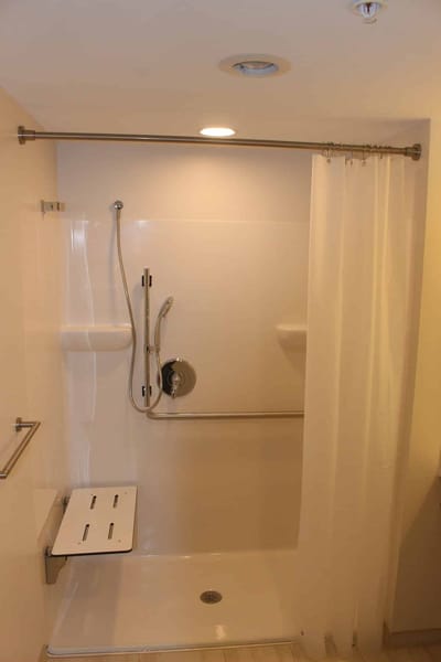 Accessible shower stall in a facility bathroom.