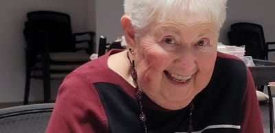 Smiling senior woman in a social environment.