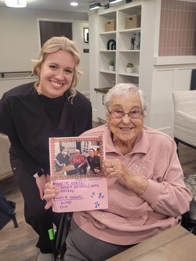 Staff member and resident holding a memory card