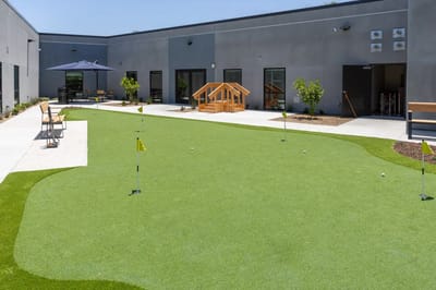 Outdoor putting green with seating area